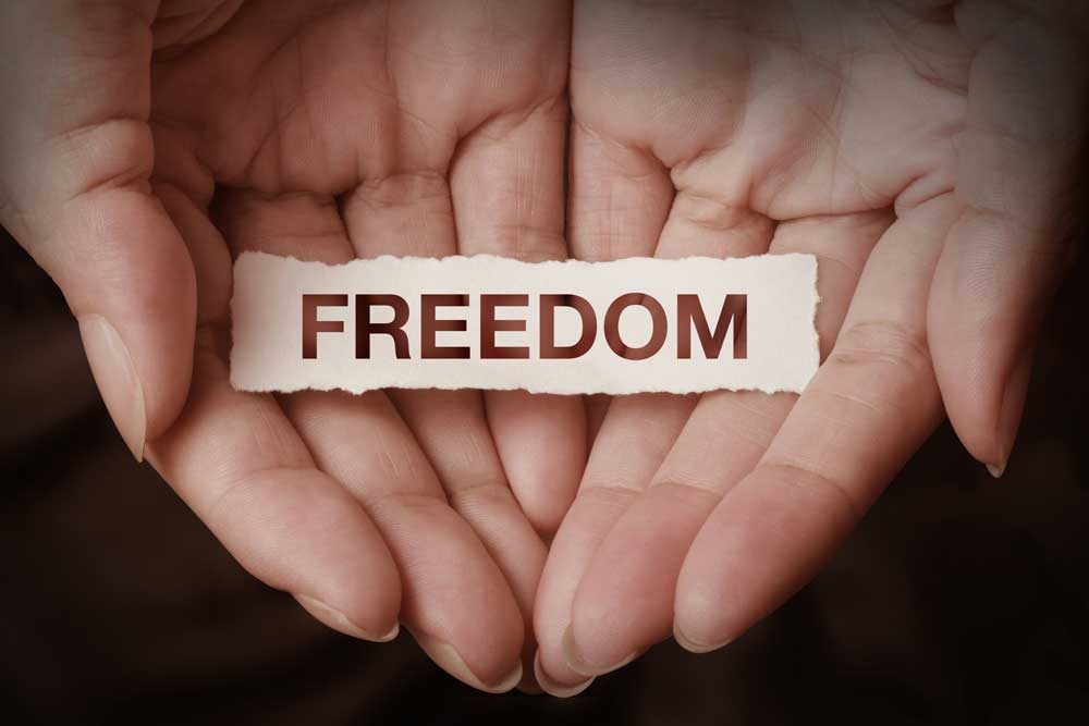 hands holding the word freedom - freedom from addiction