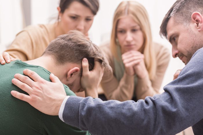 concerned family gathered around loved one