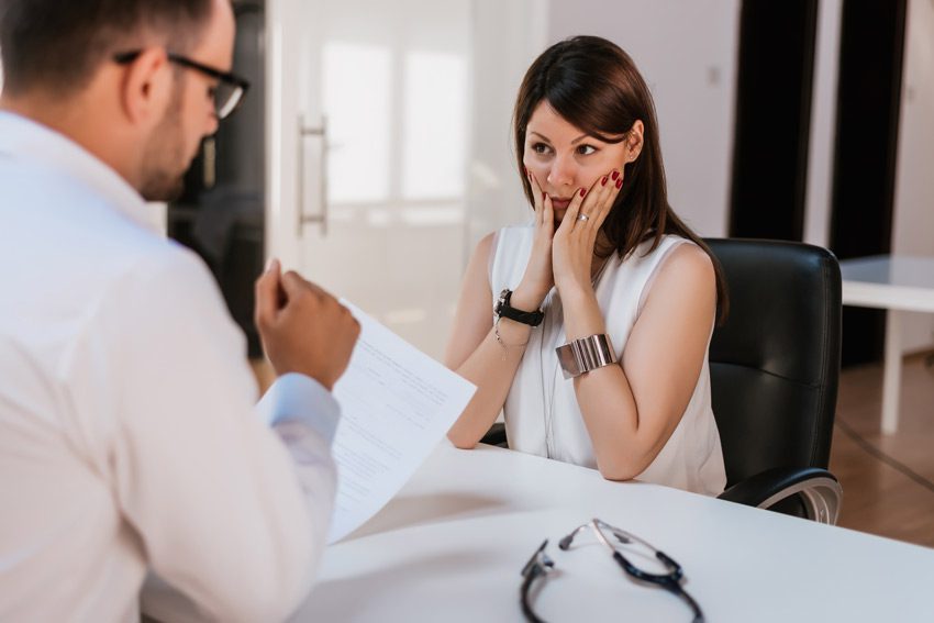 worried woman talking to doctor