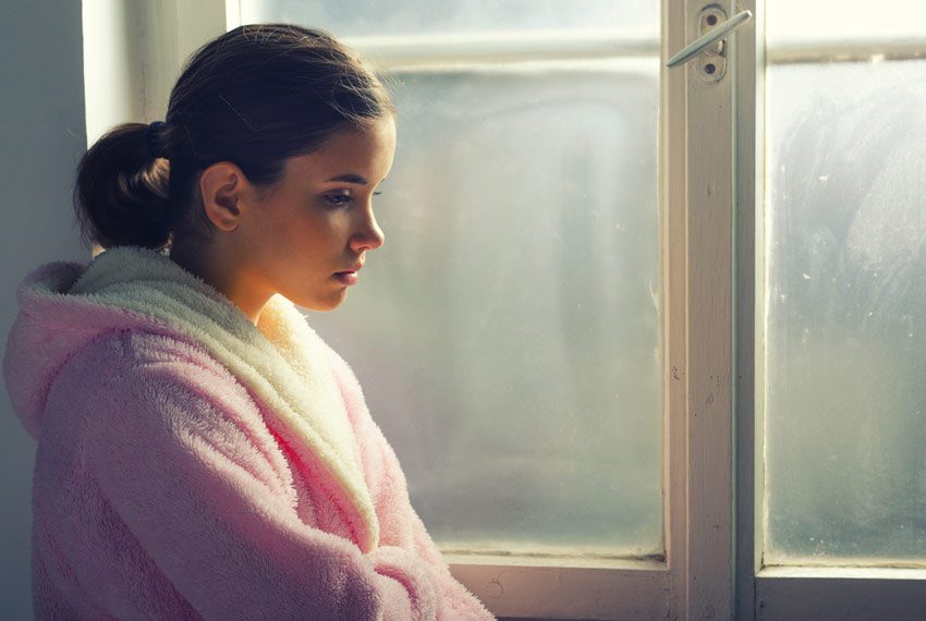 sad young woman in robe