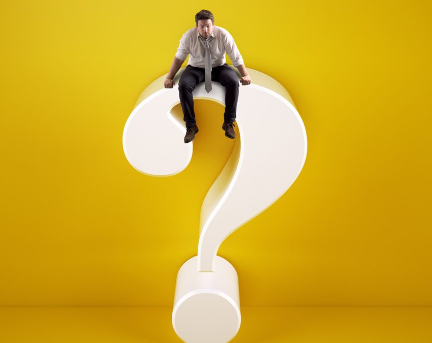 man sitting on top of white question mark on yellow background - high-functioning